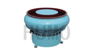 Vibratory finishing machine with curved wall bowl